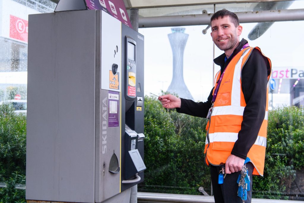 Man using car park pay machine
